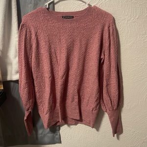 I am selling a pink sweater. It is a crewneck. It is a size medium